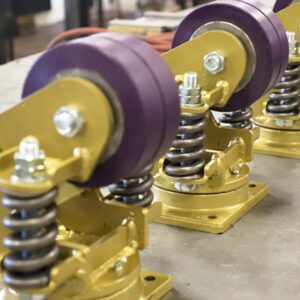 Shock absorbing casters are usually spring loaded